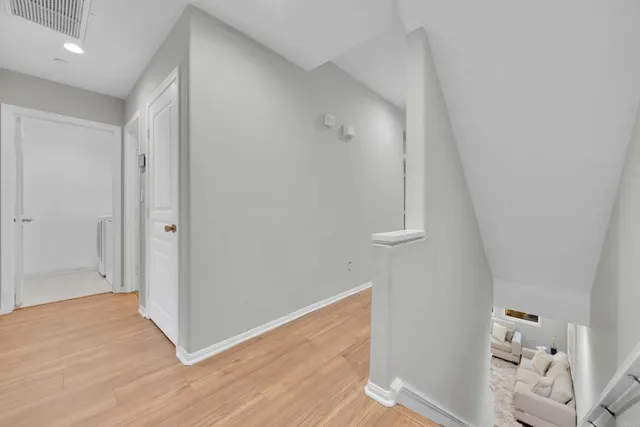 an empty room with wooden floor and closet
