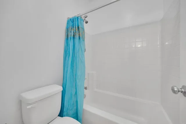 a bathroom with a toilet and a bathtub