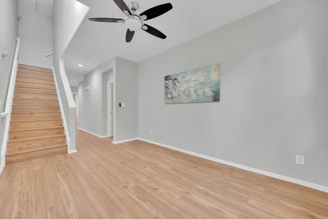 wooden floor in an empty room with a chandelier