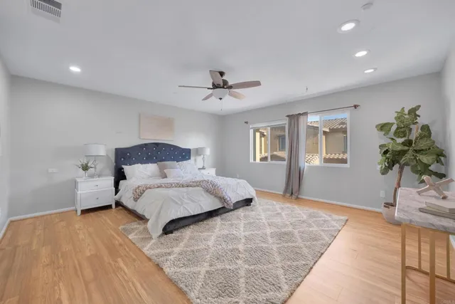 a bedroom with a large bed and a chandelier