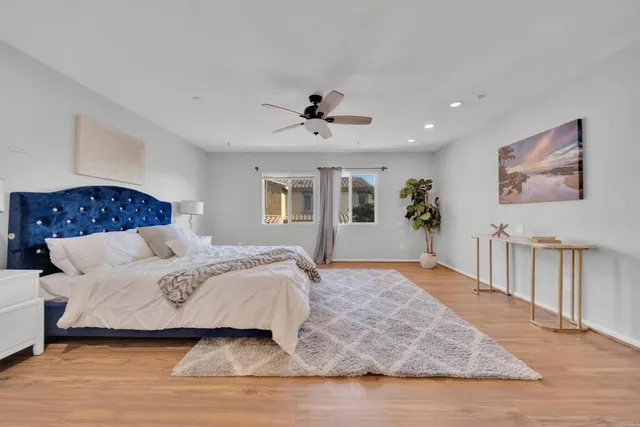 a bedroom with a large bed and a chandelier