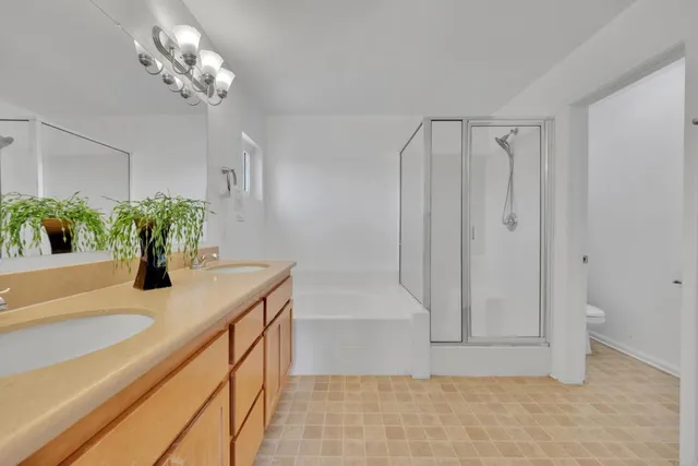 a bathroom with a granite countertop sink a toilet and a bathtub
