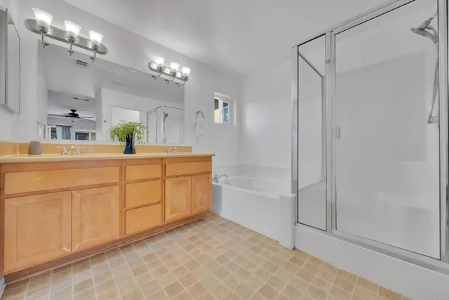 a bathroom with a sink a faucet a mirror and a shower