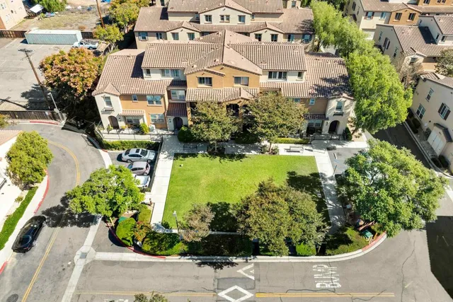 an aerial view of a house with a yard and garden