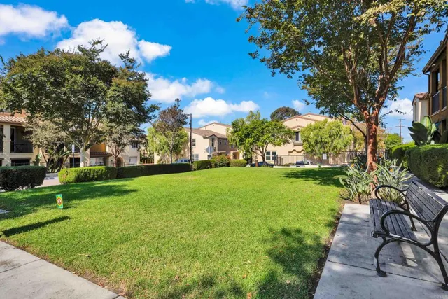a view of yard with swimming pool and green space