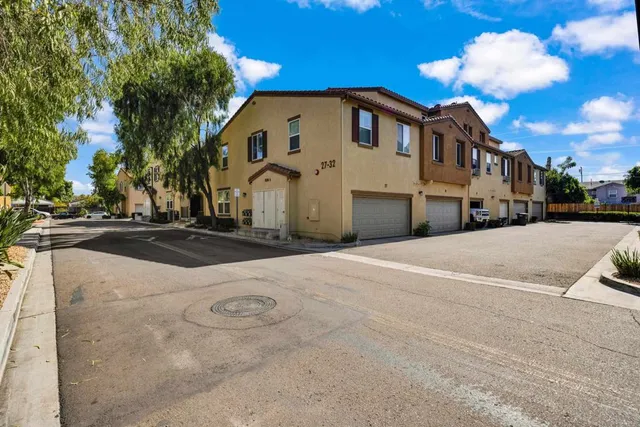 a view of a white house with a yard