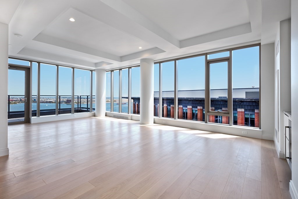 135 Seaport Boulevard, Unit PH3A Boston, MA 02210 - Photo 2 of 11 wooden floor in an empty room with a window