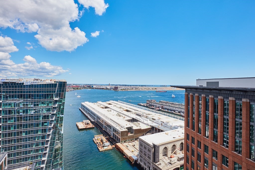 135 Seaport Boulevard, Unit PH3A Boston, MA 02210 - Photo 5 of 11 a view of a roof deck with wooden floor and fence