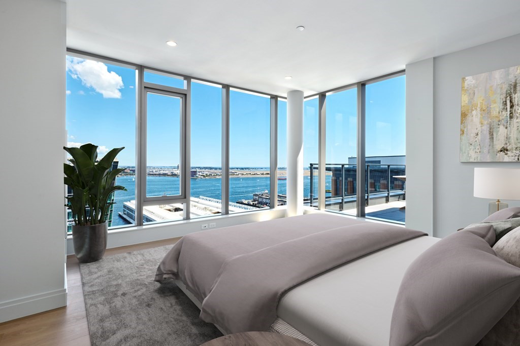 135 Seaport Boulevard, Unit PH3A Boston, MA 02210 - Photo 8 of 11 a bedroom with a large bed and a large window with outer view