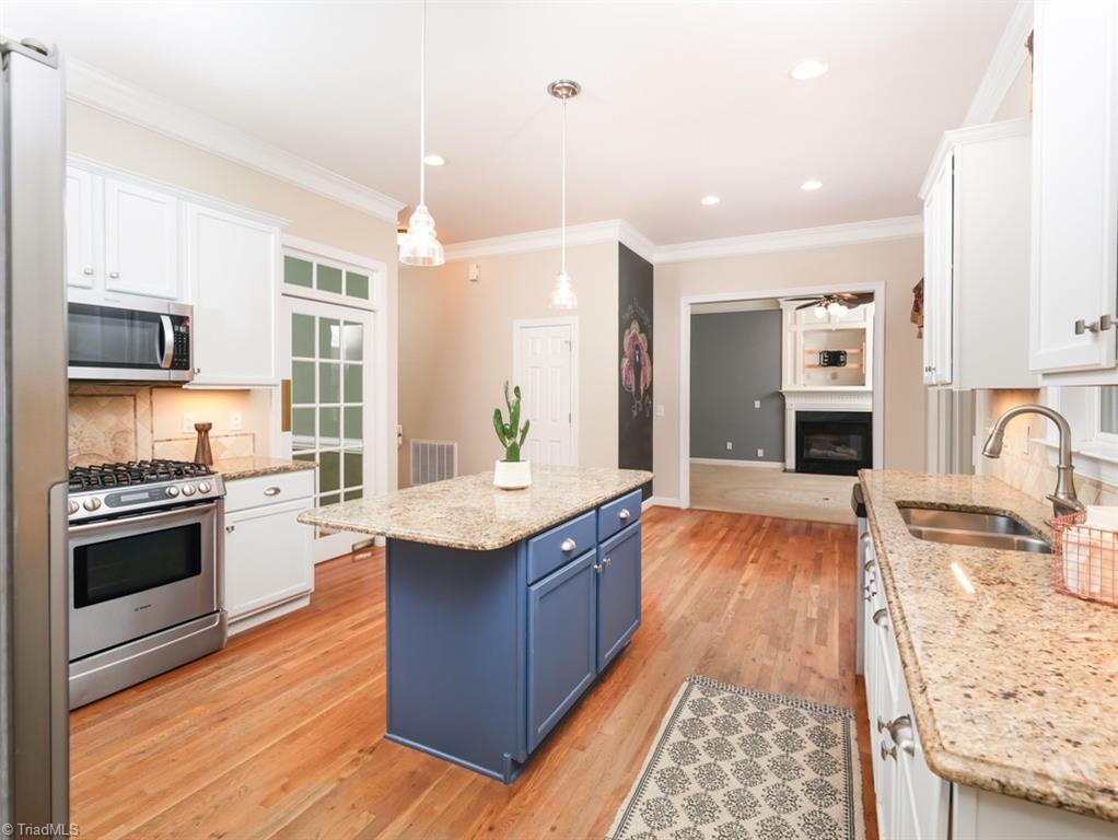 7840 Wilson Farm Road Summerfield, NC 27358 - Photo 11 of 47 Large kitchen with island, granite countertops and stainless steel appliances.