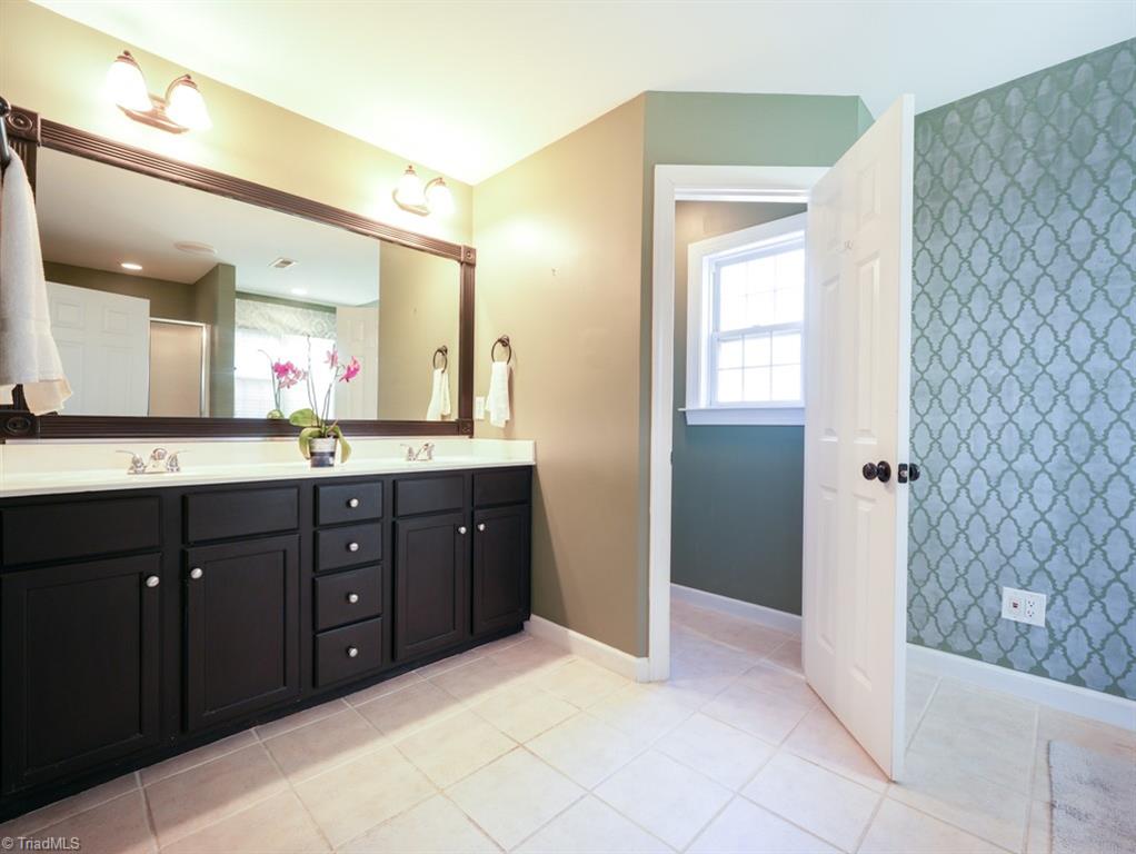 7840 Wilson Farm Road Summerfield, NC 27358 - Photo 23 of 47 Primary ensuite bathroom with double vanity.