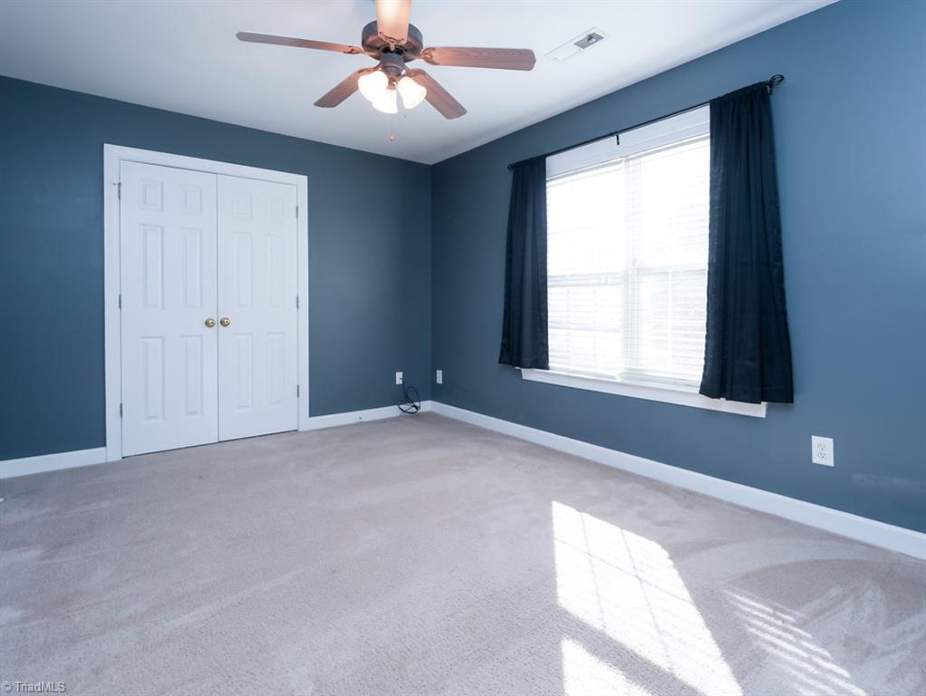 7840 Wilson Farm Road Summerfield, NC 27358 - Photo 25 of 47 Additional bedroom on second level with ceiling fans in all bedrooms.