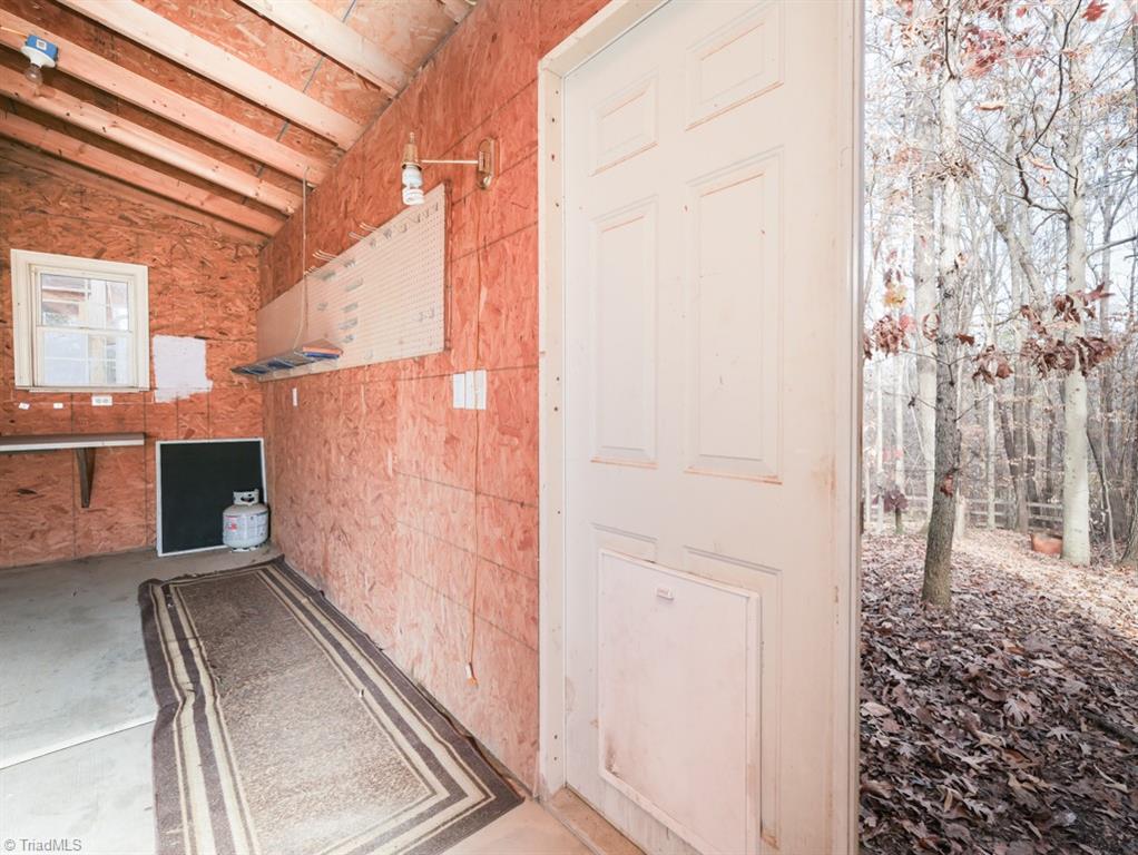 7840 Wilson Farm Road Summerfield, NC 27358 - Photo 40 of 47 One of two wired walk-in storage areas which can be also used as an workshop.
