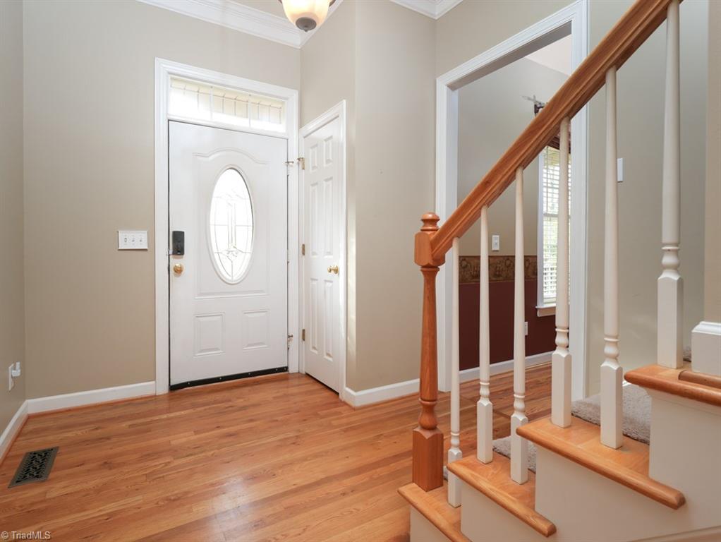 7840 Wilson Farm Road Summerfield, NC 27358 - Photo 6 of 47 Entryway from front door entrance with hardwoods.