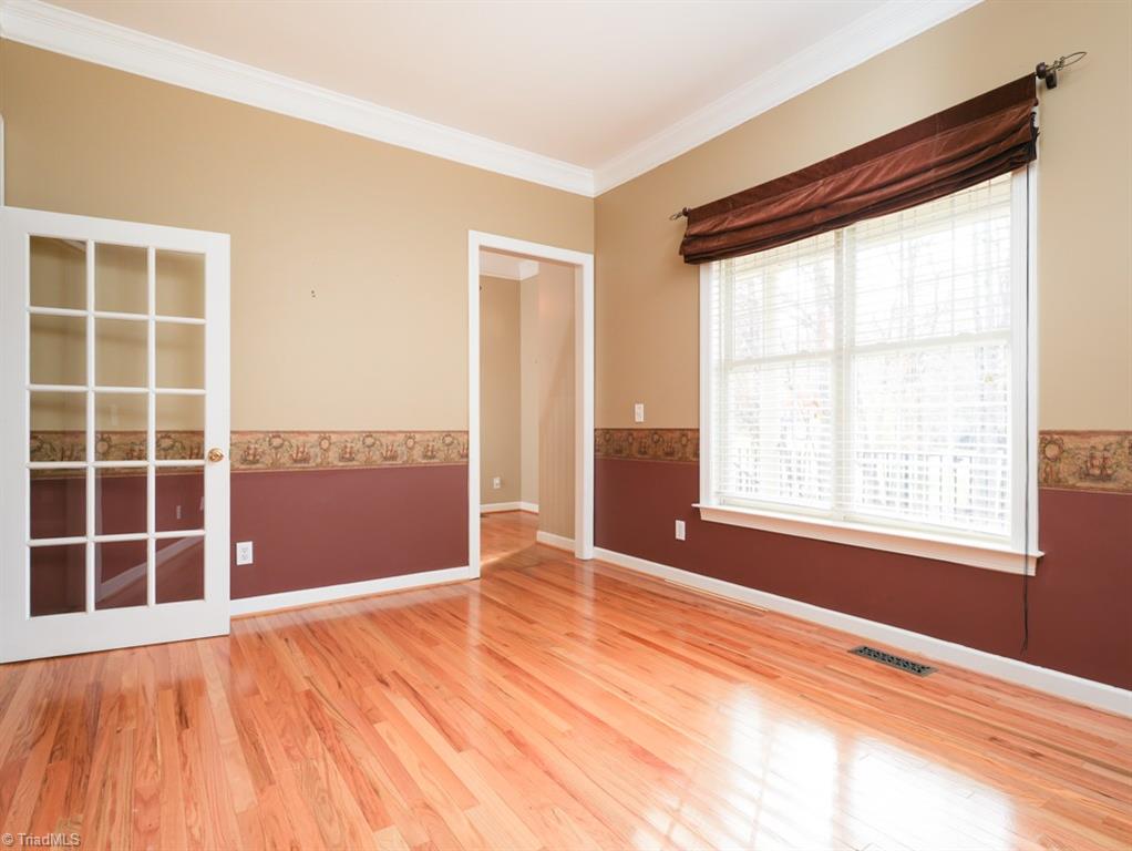 7840 Wilson Farm Road Summerfield, NC 27358 - Photo 7 of 47 Living room with continued hardwood floors and french doors.