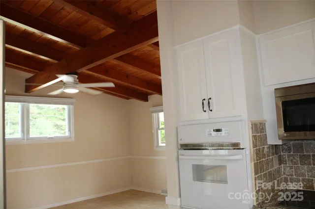 a kitchen with a refrigerator and a stove top oven