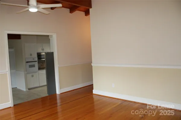 an empty room with wooden floor and closet