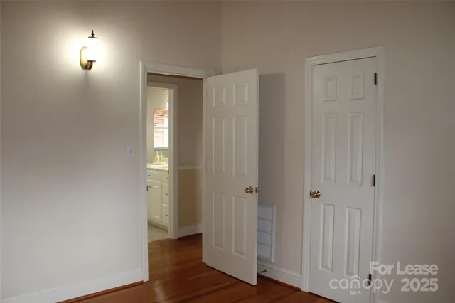 an empty room with wooden floor and closet