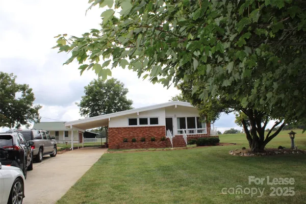 a house view with a sitting space and garden