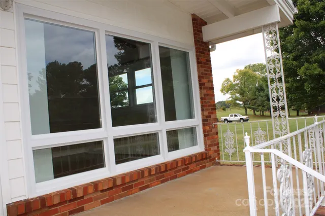 a view of a balcony with wooden floor and outdoor space
