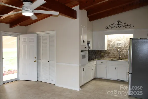 a bathroom with a granite countertop sink a mirror and a shower