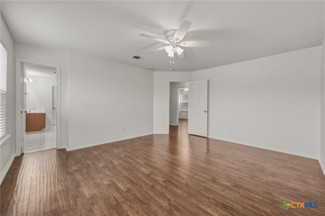 109 Comal Cove Elgin, TX 78621 - Photo 23 of 34 a view of an empty room and wooden floor