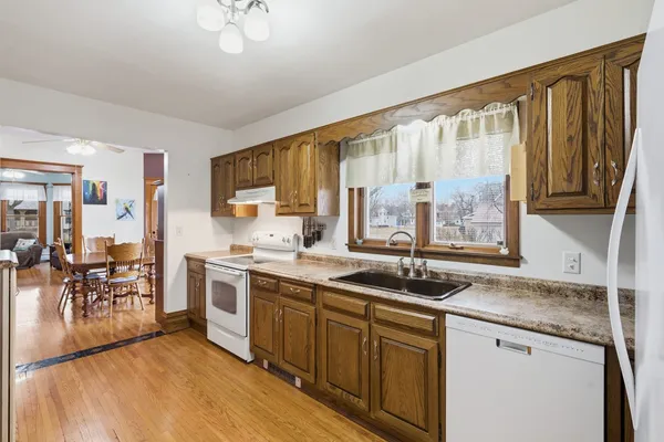 a kitchen with a sink a refrigerator and cabinets