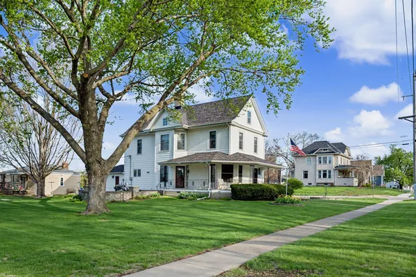 a front view of a house with a garden