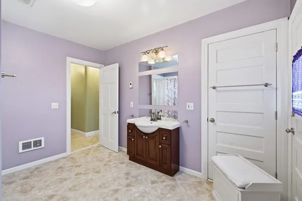 a bedroom with a bed and ceiling fan