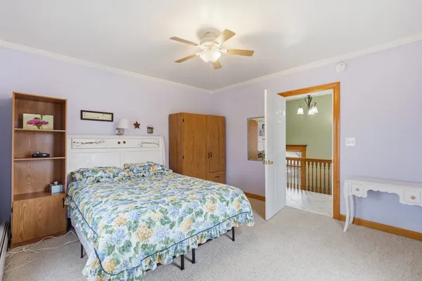 a view of a livingroom with furniture and a ceiling fan