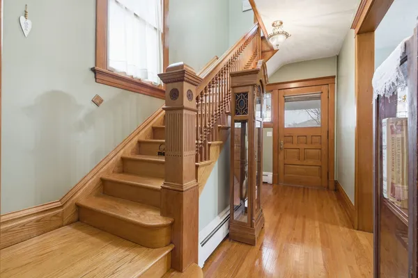 a dining room with furniture a fireplace and wooden floor