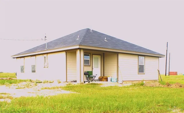 a view of a house with pool and a yard