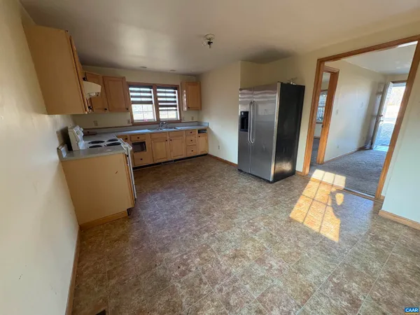 a view of a hallway with wooden floor and a cabinet