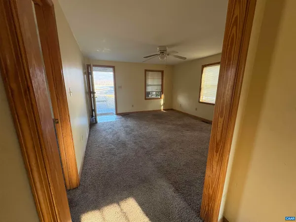 a view of an empty room and a window