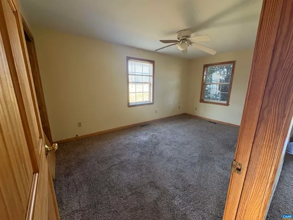 a view of a wooden fence next to a yard