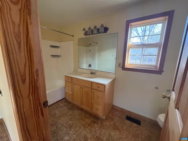 a kitchen with refrigerator and window