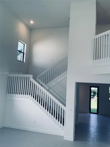 a view of staircase with white walls and stairs