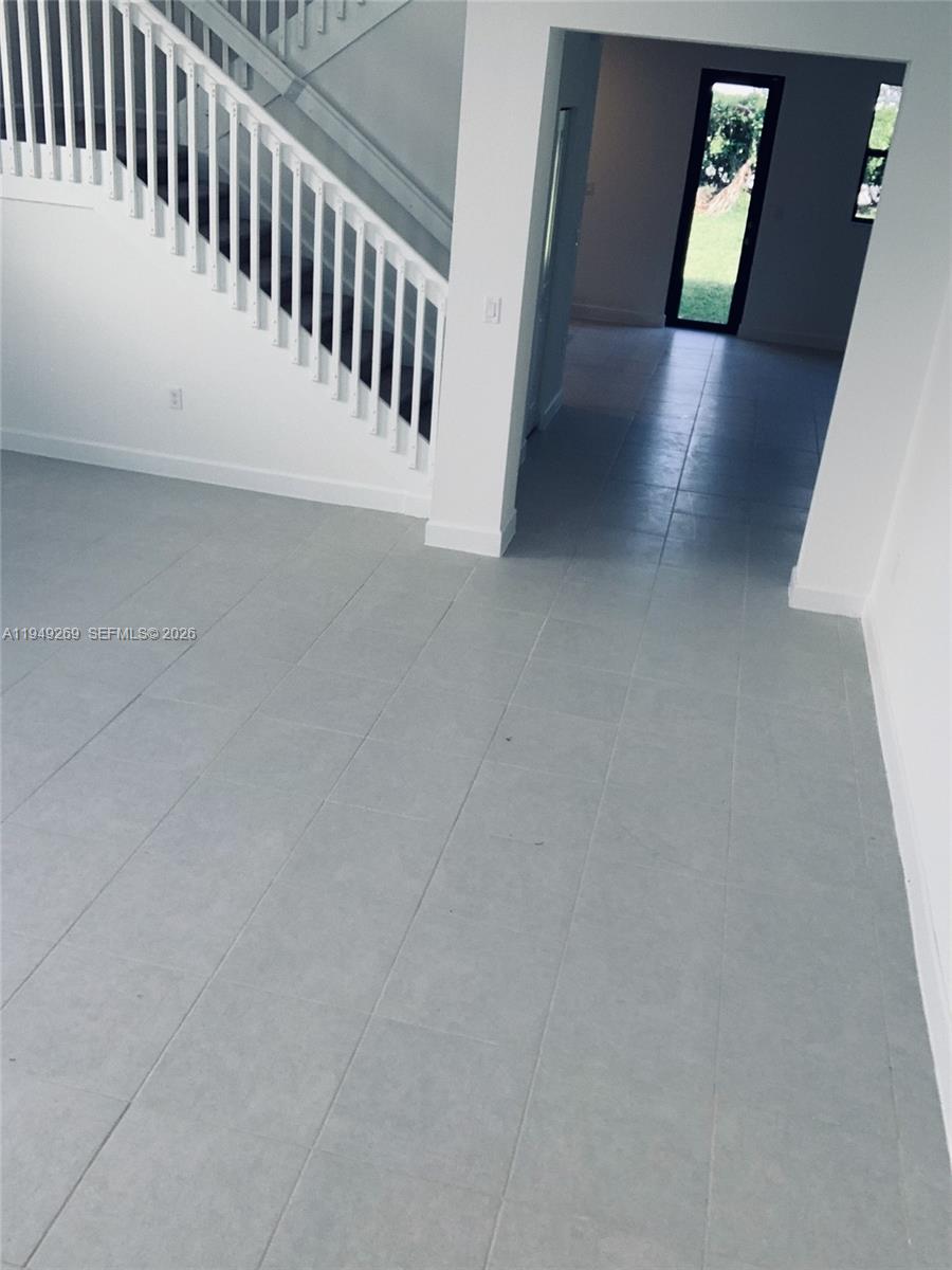 157 Northeast 27th Terrace, Unit 157 Homestead, FL 33033 - Photo 9 of 12 a view of a hallway with staircase