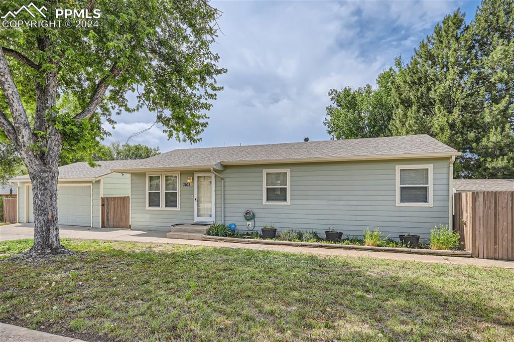 3103 Galley Road Colorado Springs, CO 80909 - Photo 1 of 25 a front view of house with yard and trees around