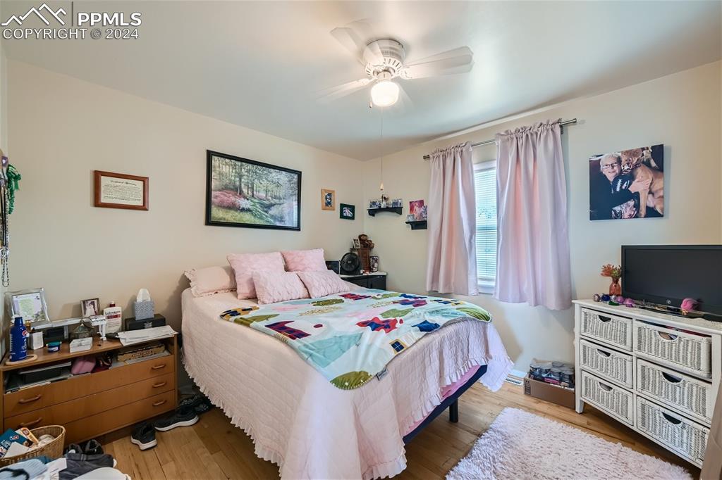 3103 Galley Road Colorado Springs, CO 80909 - Photo 12 of 25 a bedroom with a bed and a flat screen tv