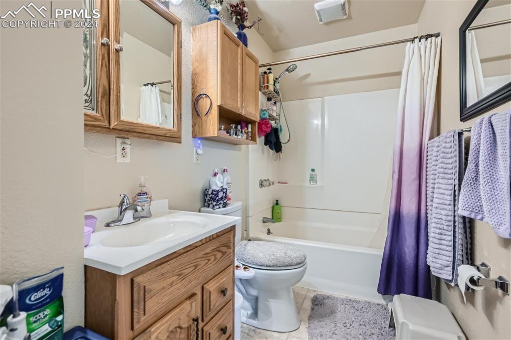 3103 Galley Road Colorado Springs, CO 80909 - Photo 14 of 25 a bathroom with a sink toilet and shower
