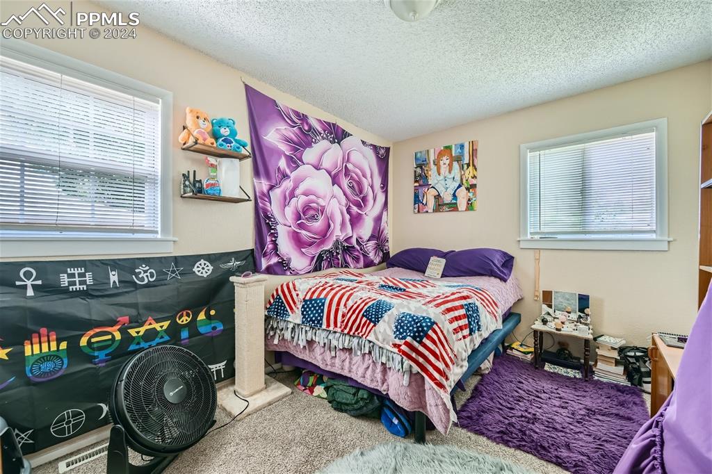 3103 Galley Road Colorado Springs, CO 80909 - Photo 16 of 25 a bedroom with a bed and a baby crib