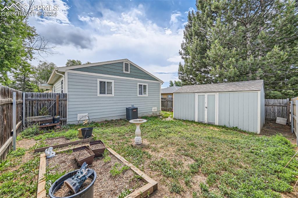 3103 Galley Road Colorado Springs, CO 80909 - Photo 22 of 25 a backyard of a house with lots of green space