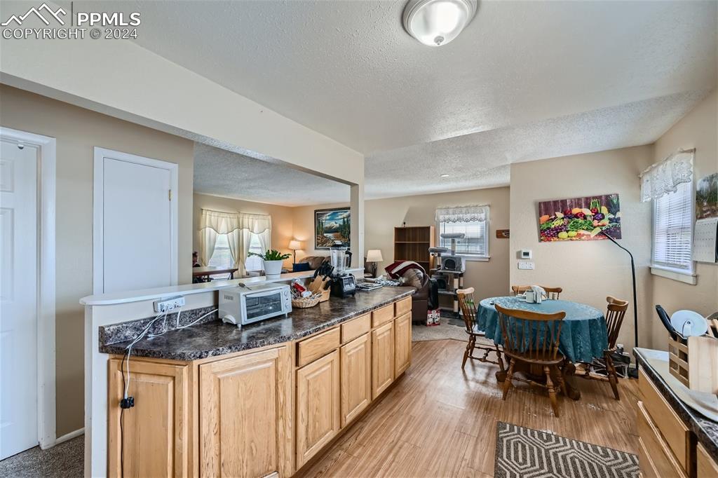 3103 Galley Road Colorado Springs, CO 80909 - Photo 8 of 25 a view of a dining room with furniture and wooden floor