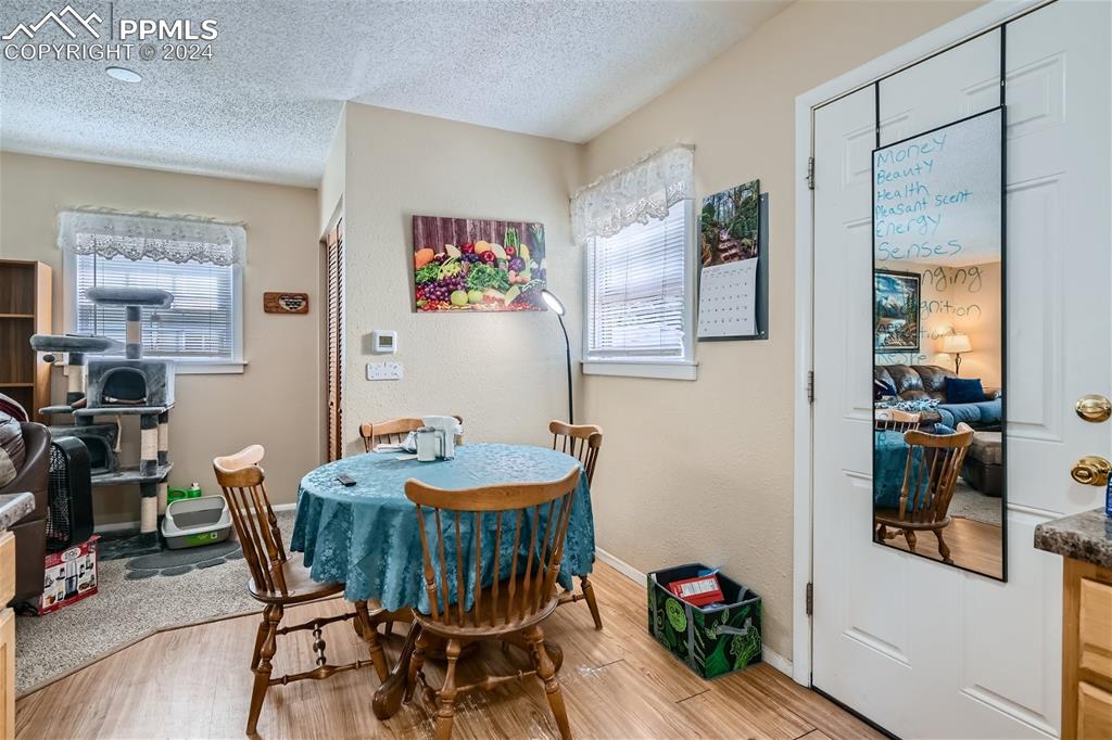 3103 Galley Road Colorado Springs, CO 80909 - Photo 9 of 25 a dining room with furniture and wooden floor