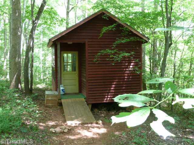 1100 Hemlock Ridge Road Germanton, NC 27019 - Photo 16 of 16 Studio/Study/Office. This Artist Studio sits in the trees behind the home. It has electricity and an entire wall of windows. If you are an artist you need to see this home.