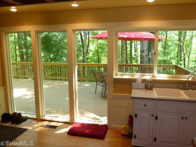 1100 Hemlock Ridge Road Germanton, NC 27019 - Photo 7 of 16 Kitchen. View of the deck from the kitchen with an entire wall of double pane windows. Tons of natural light and fantastic views of your 2 acre slice of heaven.