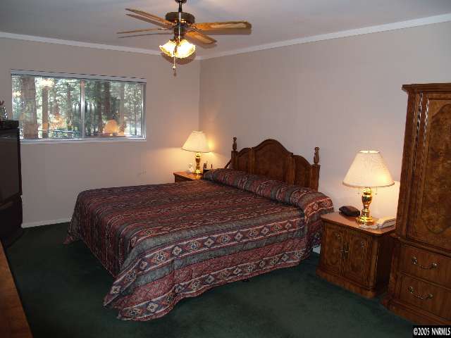 266 Chimney Rock Road Stateline, NV 89449 - Photo 5 of 9 a bedroom with a bed and a lamp on dresser