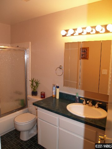 266 Chimney Rock Road Stateline, NV 89449 - Photo 6 of 9 a bathroom with a granite countertop sink and a mirror