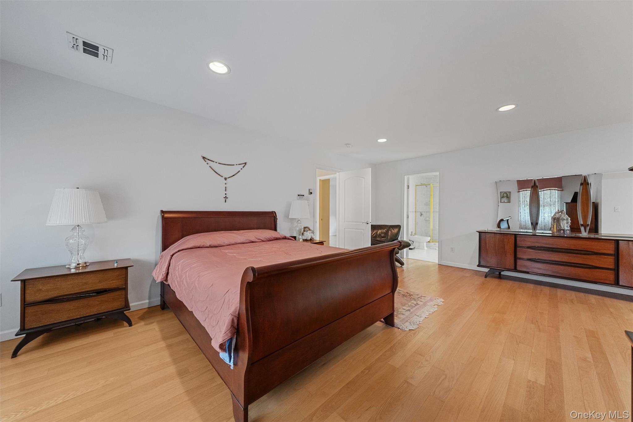 20 Goshen Road Chester, NY 10918 - Photo 26 of 38 a spacious bedroom with a bed and a lamp with wooden floor